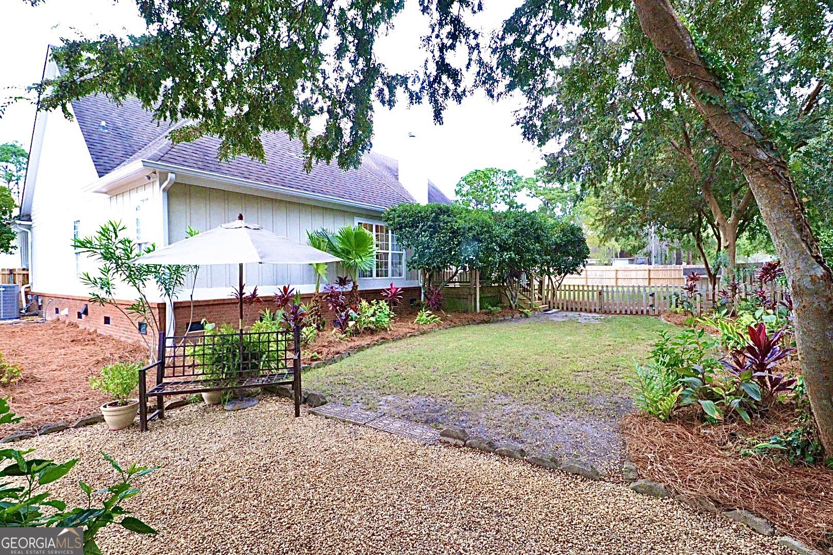 1410 Forest Way Nashville, GA 31639 - Photo 28 of 76 a front view of a house with a garden and tree