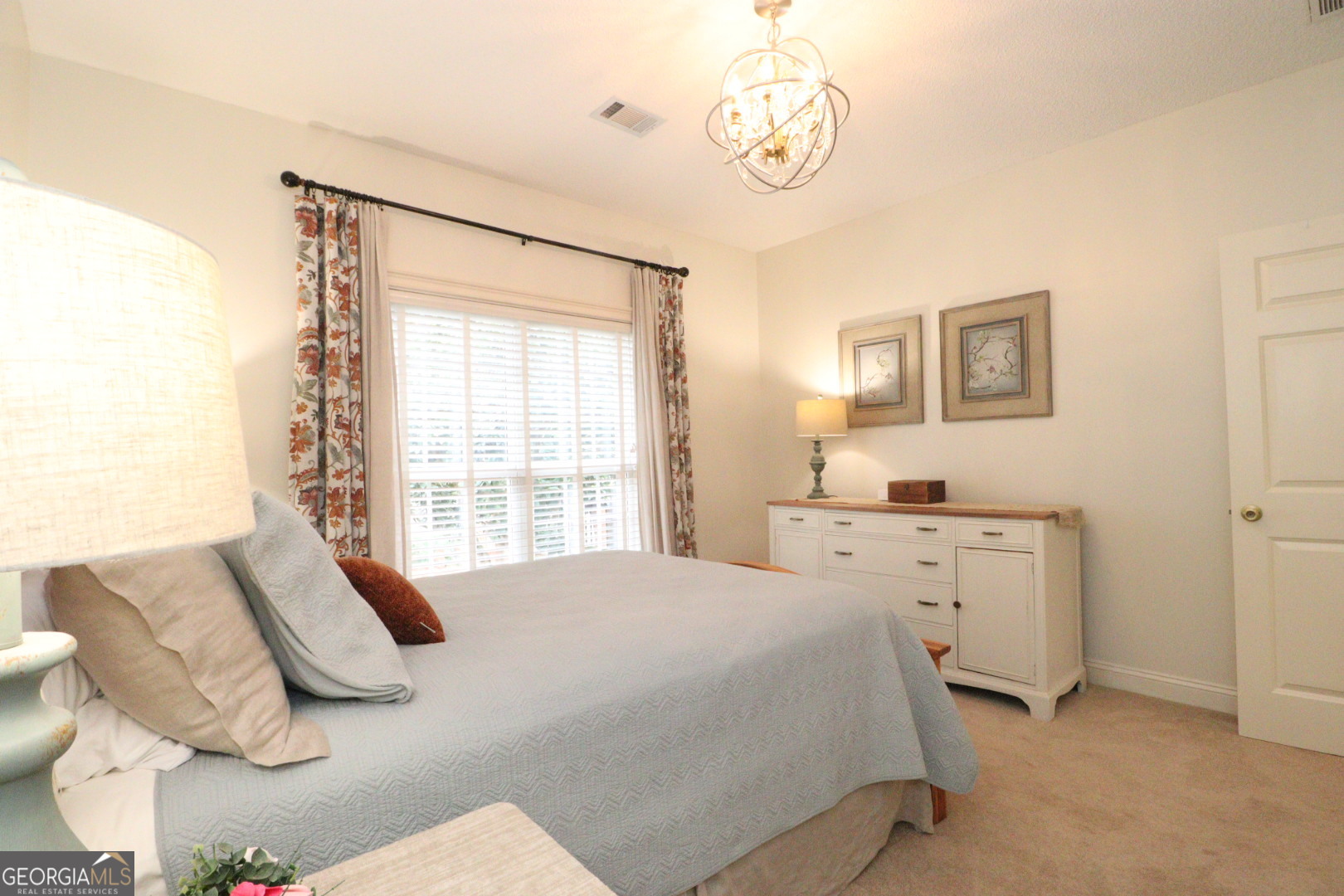 1410 Forest Way Nashville, GA 31639 - Photo 52 of 76 a spacious bedroom with a bed and a table in it