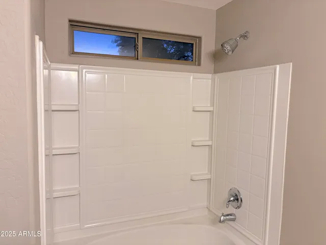a bathroom with a shower and a sink