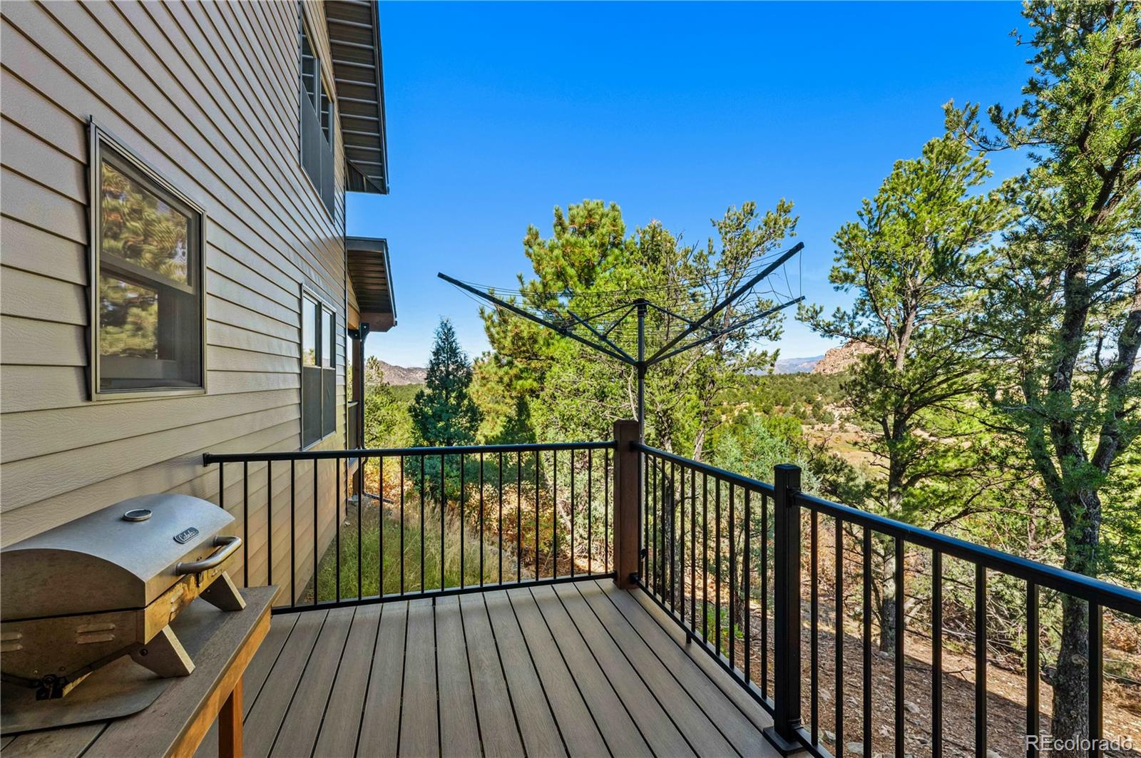 1310 Sunrise Ridge Cotopaxi, CO 81223 - Photo 37 of 50 a view of a balcony with wooden floor and fence