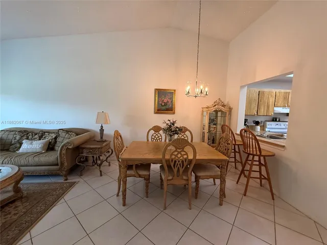 a living room with furniture and a dining table