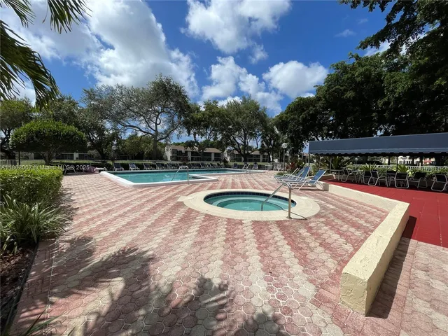 a view of a swimming pool with a patio