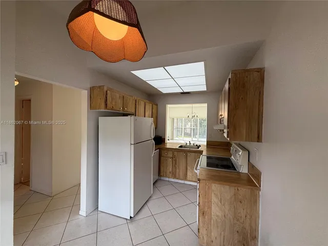 a kitchen with stainless steel appliances granite countertop a refrigerator and a stove