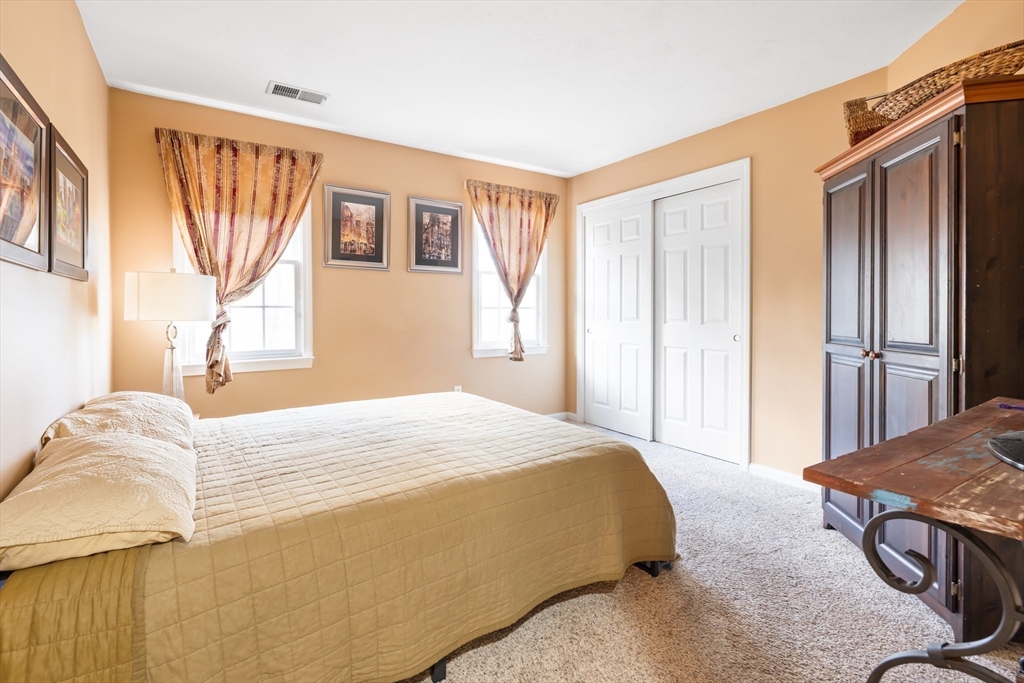 162 Ewald Avenue Marlborough, MA 01752 - Photo 17 of 30 a bedroom with a bed and a dresser next to a window