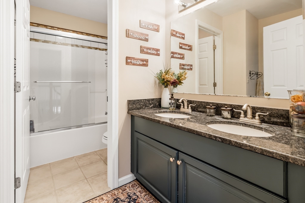 162 Ewald Avenue Marlborough, MA 01752 - Photo 19 of 30 a bathroom with a granite countertop shower sink and mirror