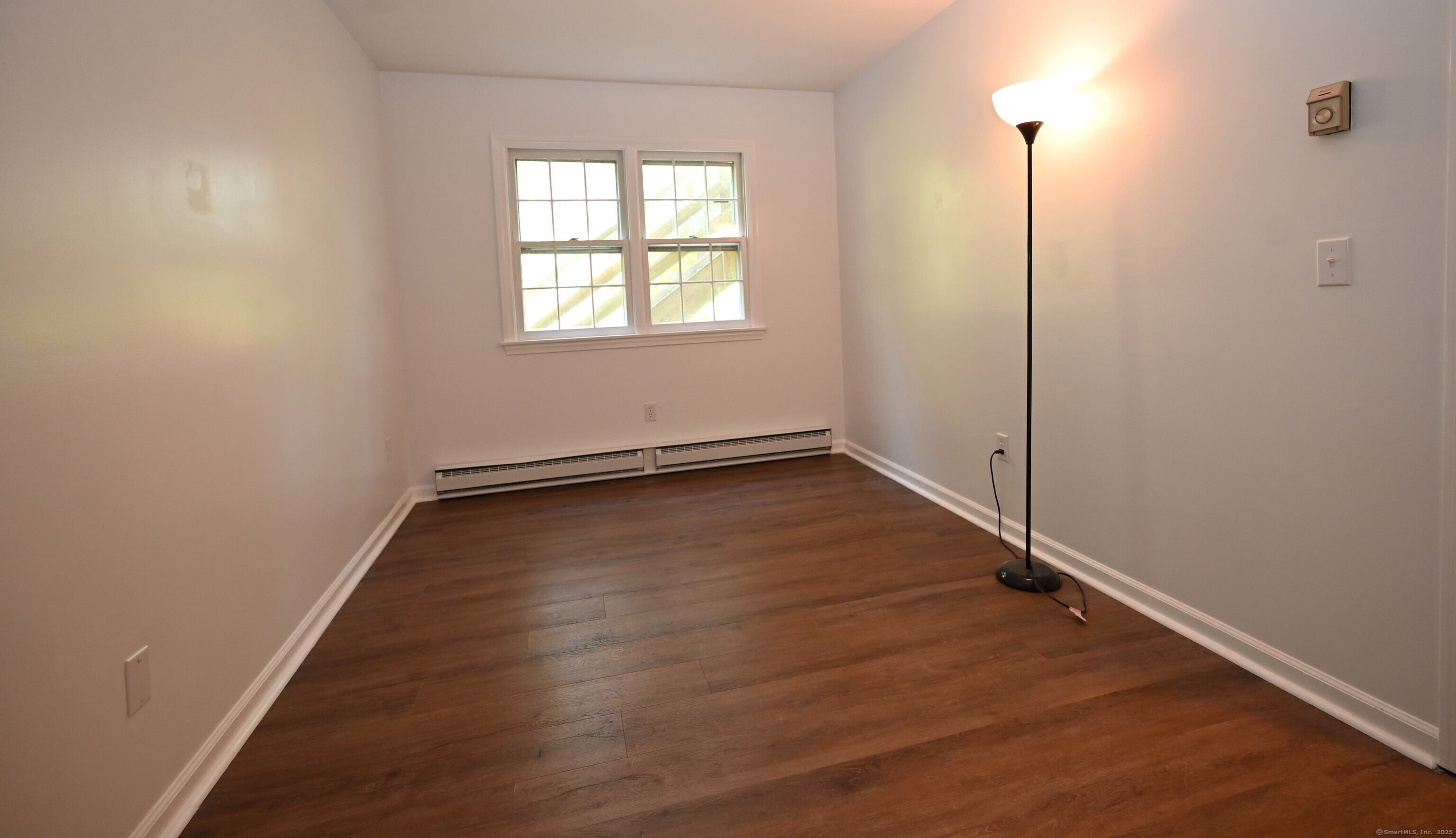 113 Union Street, Unit Z Deep River, CT 06417 - Photo 13 of 14 an empty room with wooden floor and windows