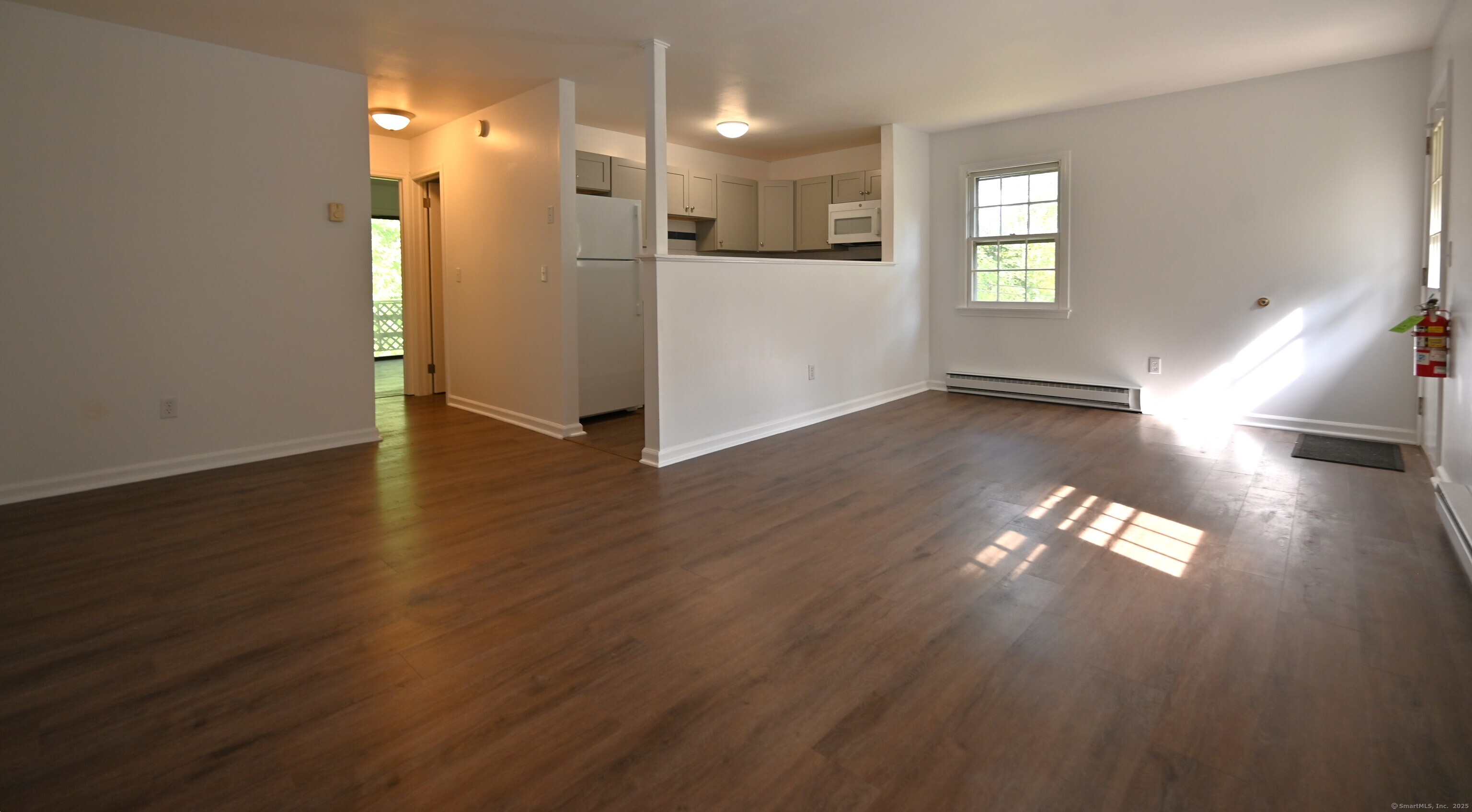 113 Union Street, Unit Z Deep River, CT 06417 - Photo 5 of 14 an empty room with wooden floor and windows