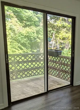 a view of a glass door with wooden floor