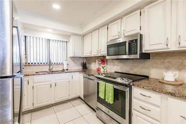 a kitchen with stainless steel appliances a refrigerator sink and cabinets