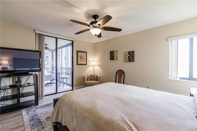 a large bed in a bedroom next to a window