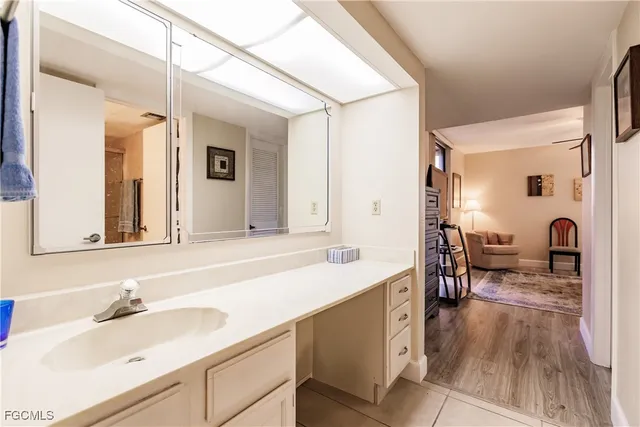 a bathroom with a granite countertop sink and a mirror