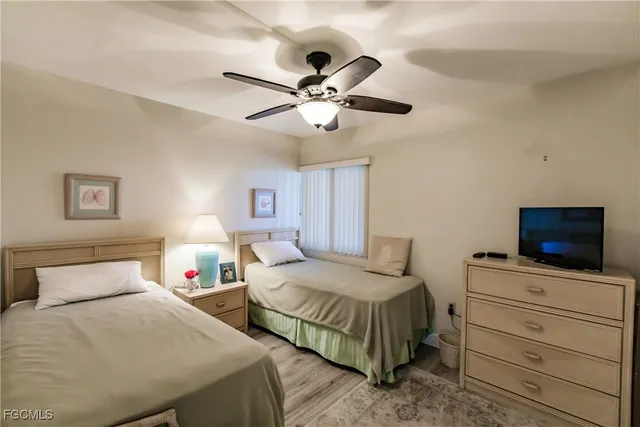 a bedroom with a bed and ceiling fan