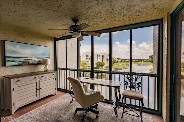 a view of a porch with furniture and a yard