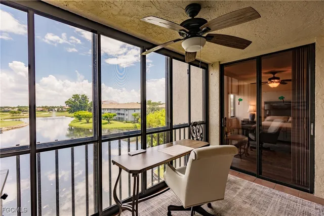 a front view of multi story residential apartment building with yard and green space