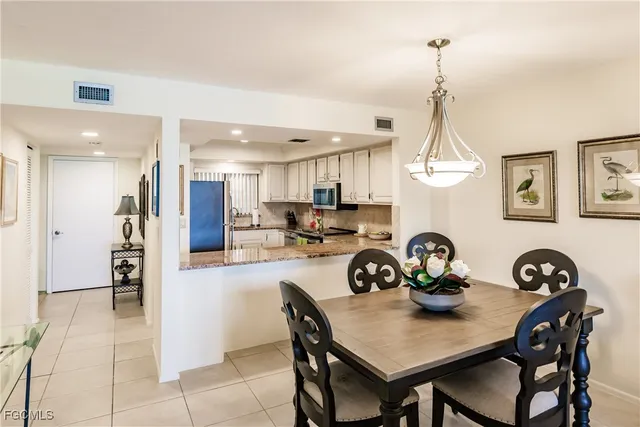 a kitchen with granite countertop white cabinets stainless steel appliances and a sink