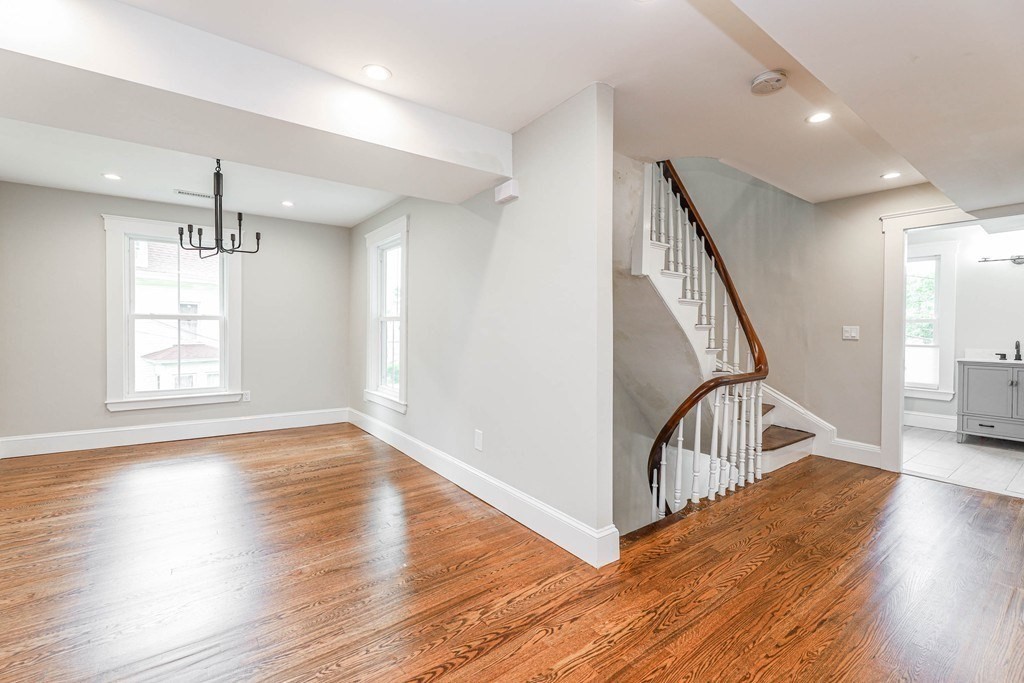 52 Maple Street, Unit 2 Boston, MA 02136 - Photo 13 of 41 a view of a livingroom with wooden floor and stairs