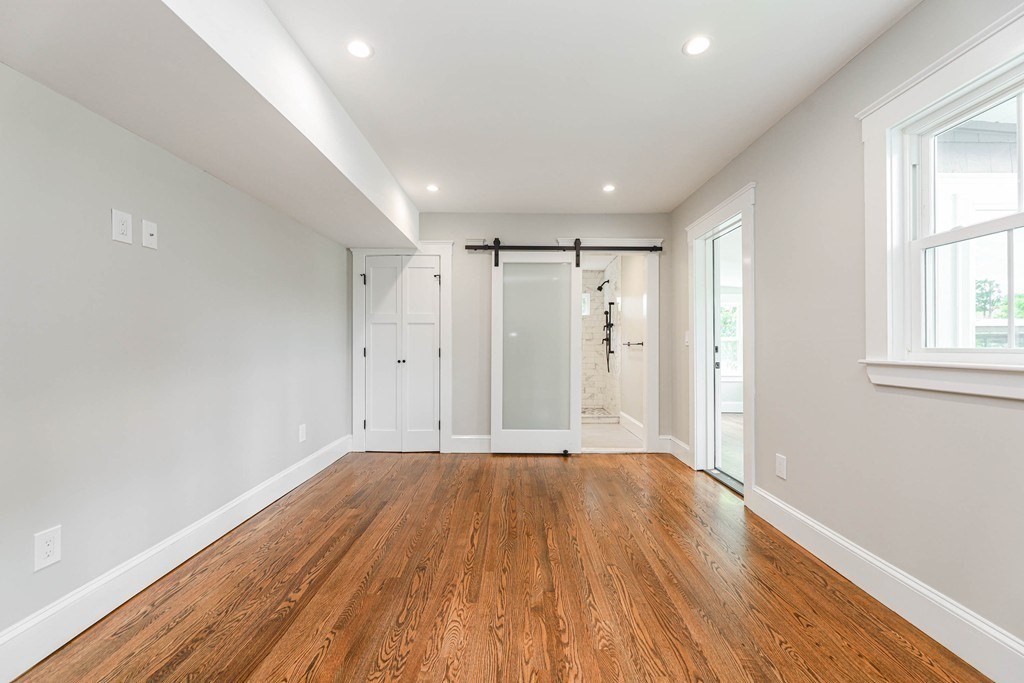 52 Maple Street, Unit 2 Boston, MA 02136 - Photo 19 of 41 a view of a big room with wooden floor and windows