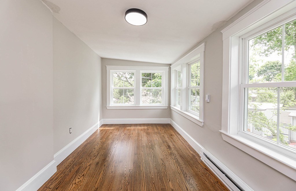 52 Maple Street, Unit 2 Boston, MA 02136 - Photo 22 of 41 a view of empty room with wooden floor and fan