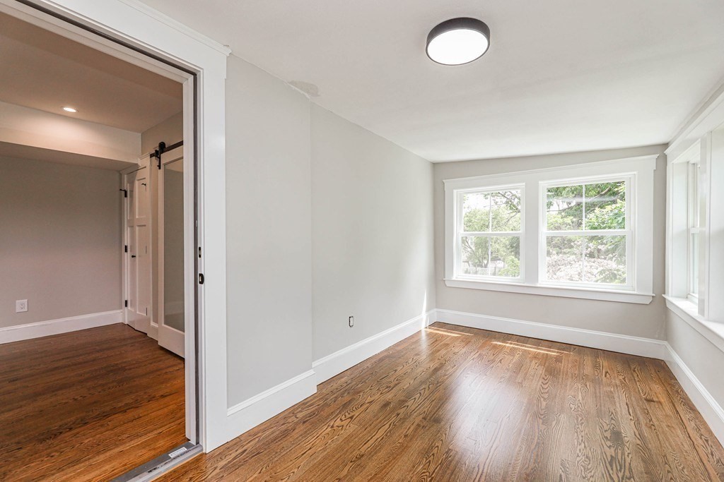52 Maple Street, Unit 2 Boston, MA 02136 - Photo 23 of 41 an empty room with wooden floor and windows