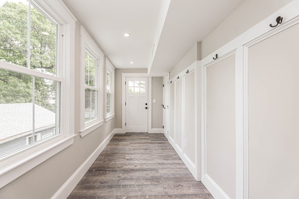 52 Maple Street, Unit 2 Boston, MA 02136 - Photo 26 of 41 a view of a hallway with wooden floor and windows