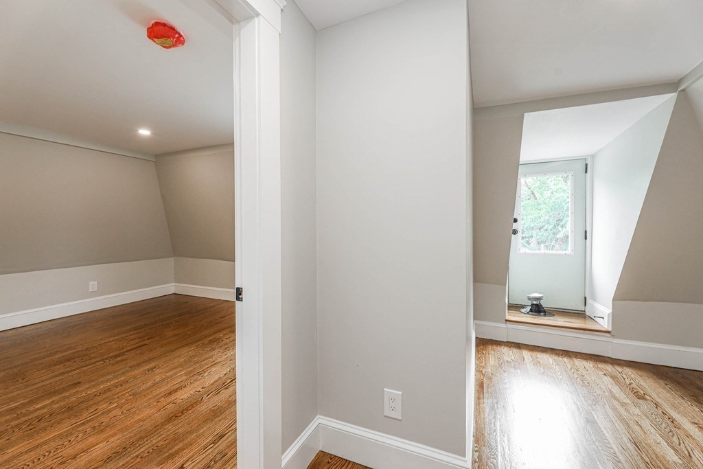 52 Maple Street, Unit 2 Boston, MA 02136 - Photo 35 of 41 a view of an empty room with wooden floor and a window