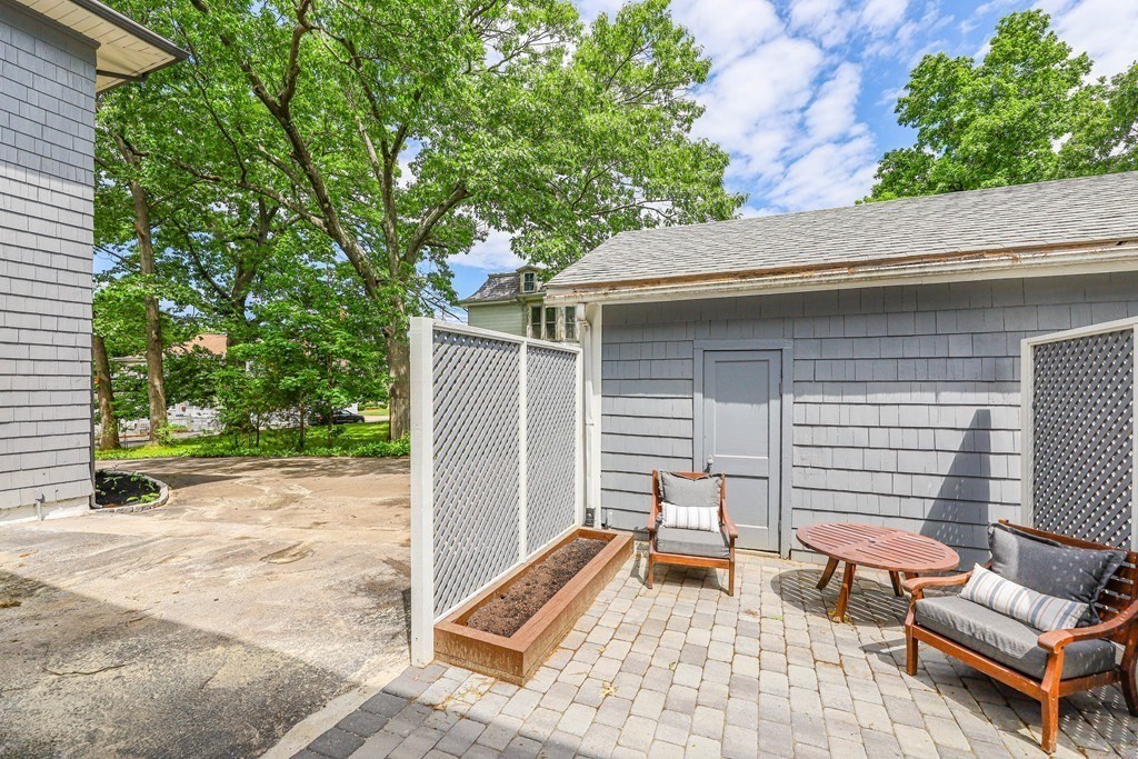 52 Maple Street, Unit 2 Boston, MA 02136 - Photo 40 of 41 a view of a patio with a table and chairs and a barbeque