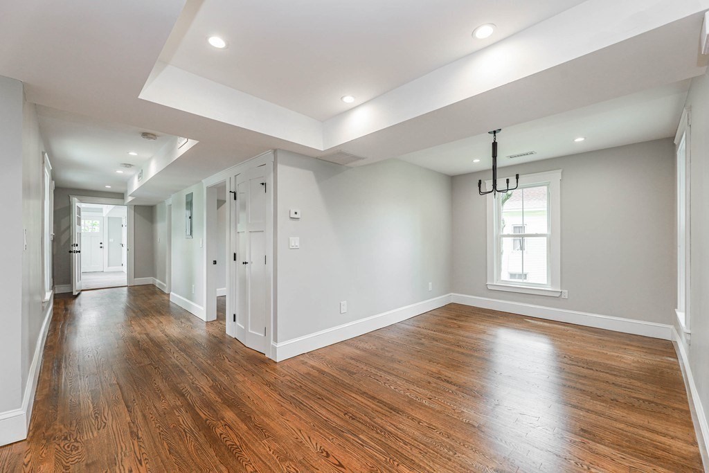 52 Maple Street, Unit 2 Boston, MA 02136 - Photo 9 of 41 an empty room with wooden floor and windows