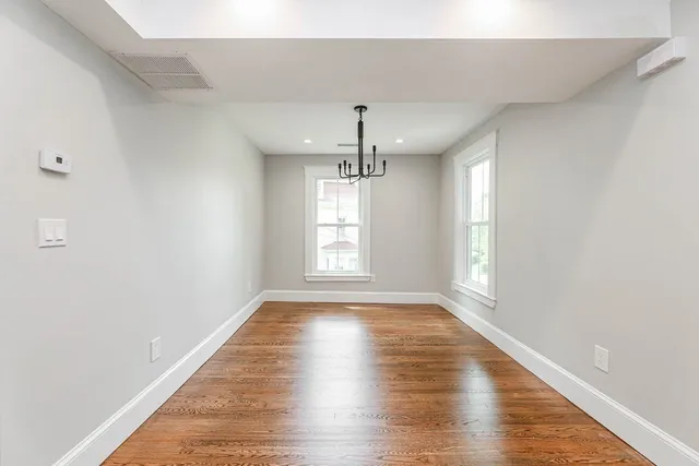 wooden floor in an empty room with window