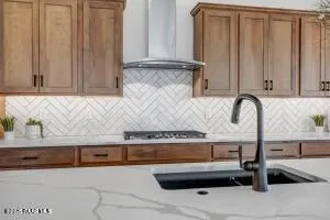 a kitchen with granite countertop a sink and a stove
