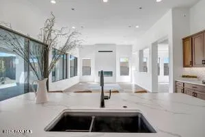 a kitchen with sink and view of living room