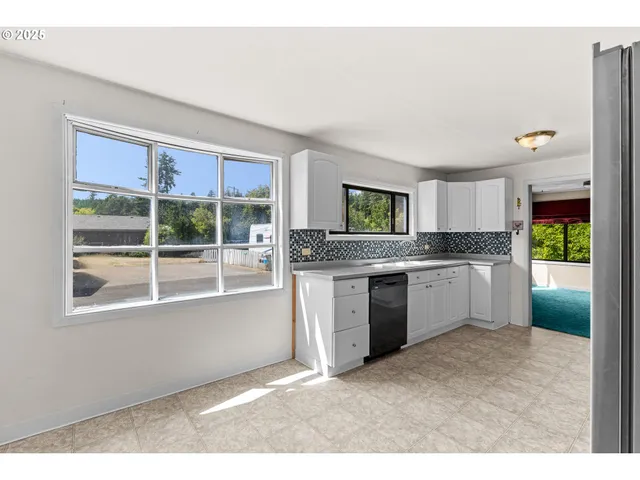 a kitchen with a refrigerator and window