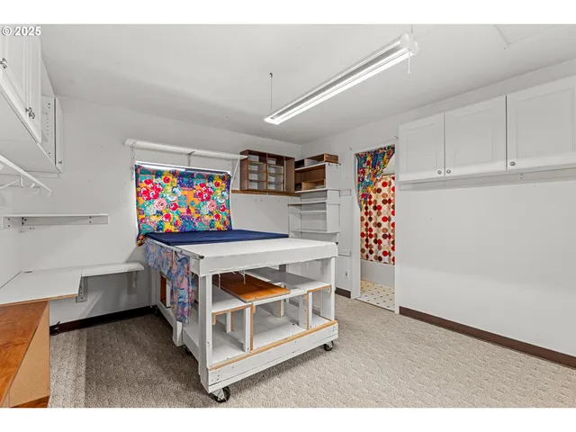 a utility room with stainless steel appliances cabinets and a wooden floor