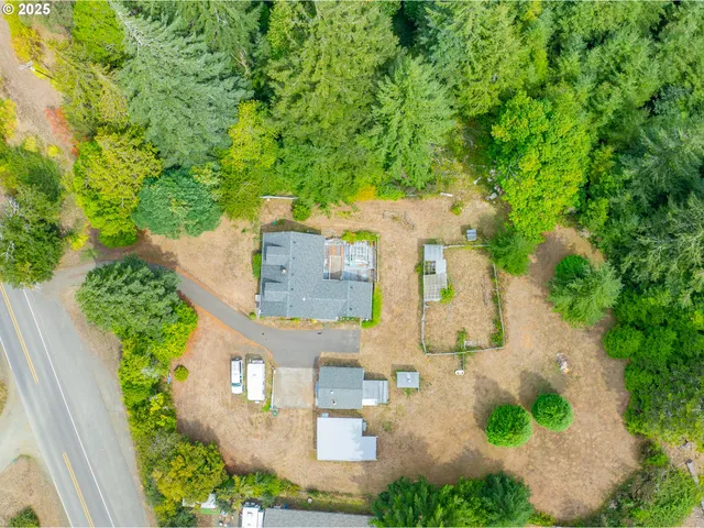 an aerial view of a house with a yard basket ball court and outdoor seating