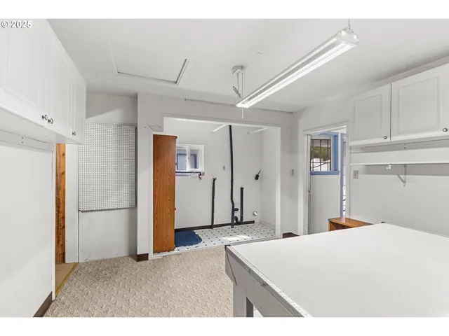 a bedroom with a bed and a refrigerator