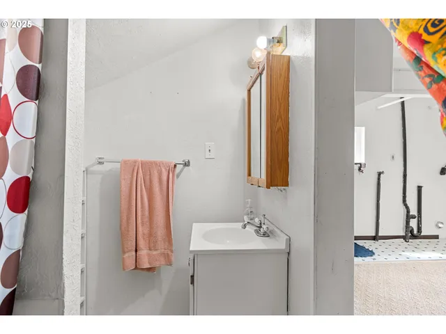 a bathroom with a sink vanity and a mirror