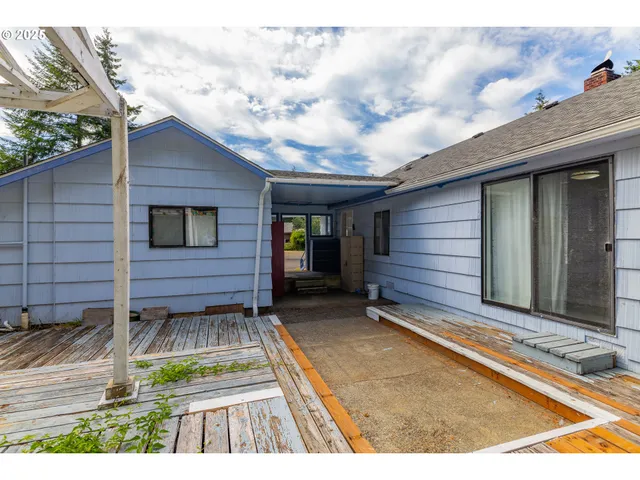 a view of backyard with a chair and wooden floor