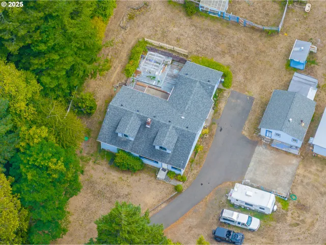 an aerial view of a house with a yard and garden