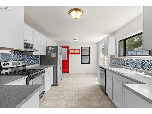 a kitchen that has a sink and a stove