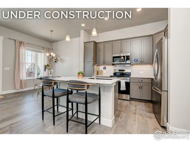 a kitchen with a sink cabinets and wooden floor