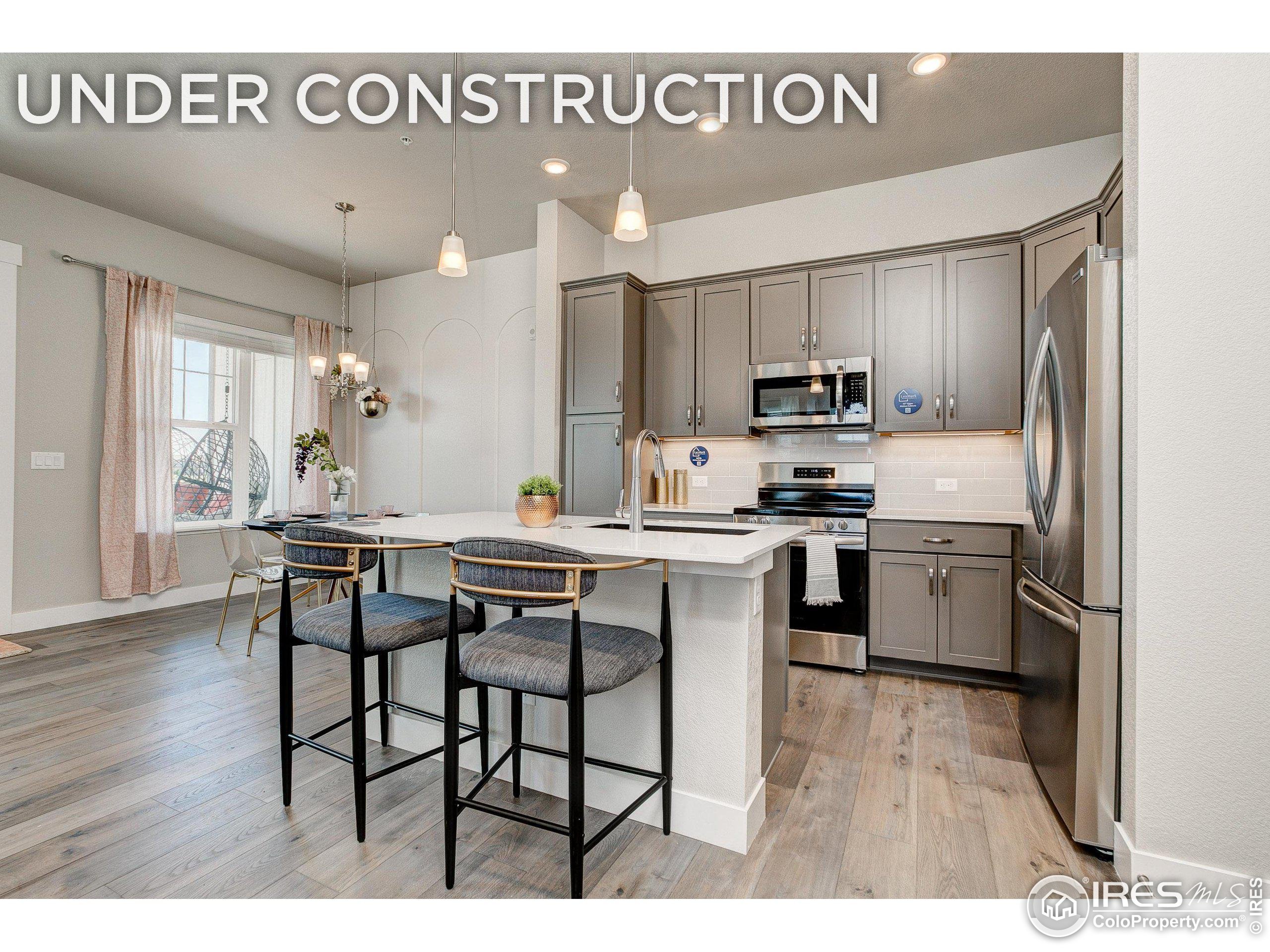 a kitchen with a sink cabinets and wooden floor