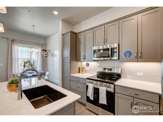 a kitchen with a sink a stove and cabinets