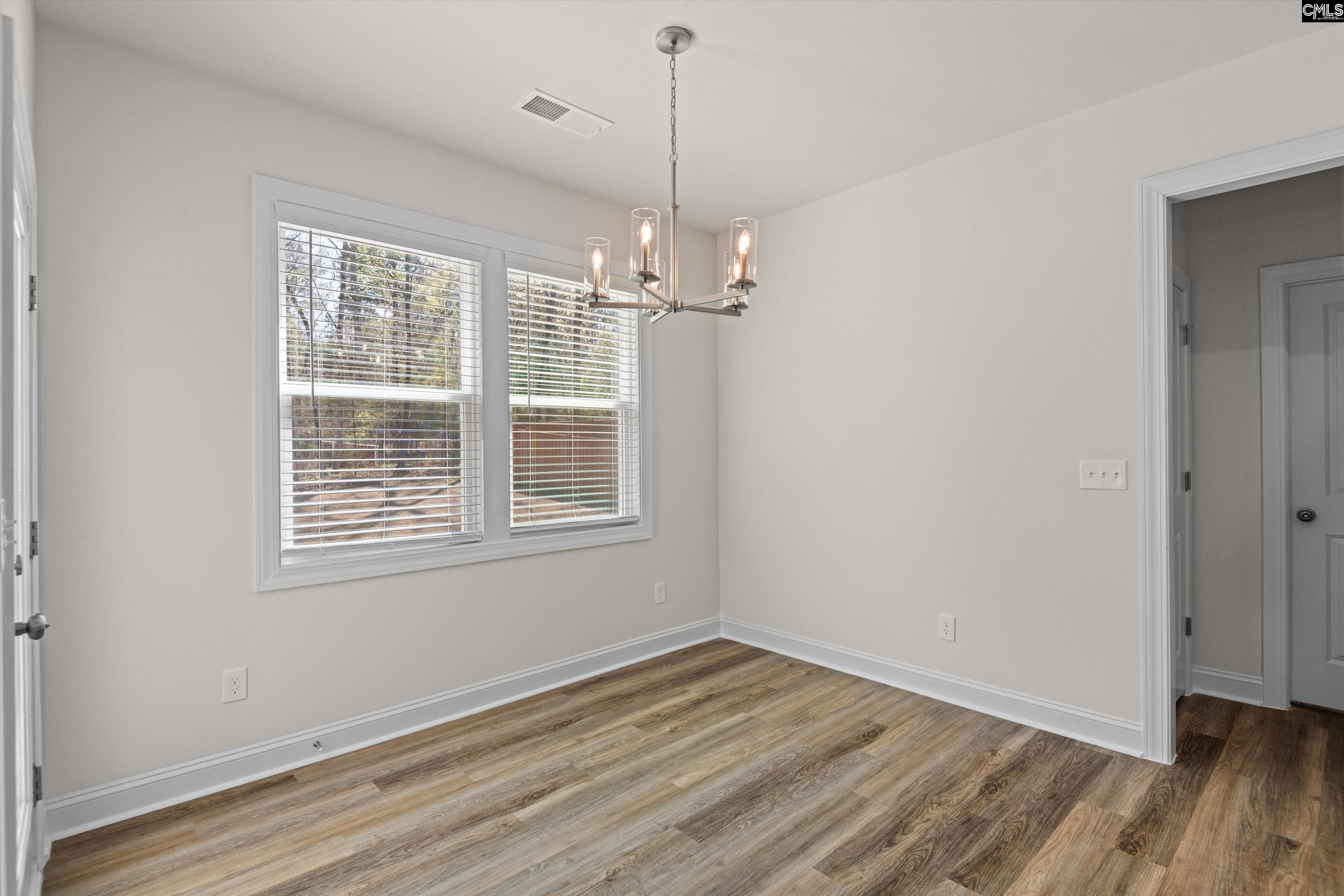 558 Wild Ginger Loop Irmo, SC 29063 - Photo 17 of 42 a view of a room with wooden floor and windows