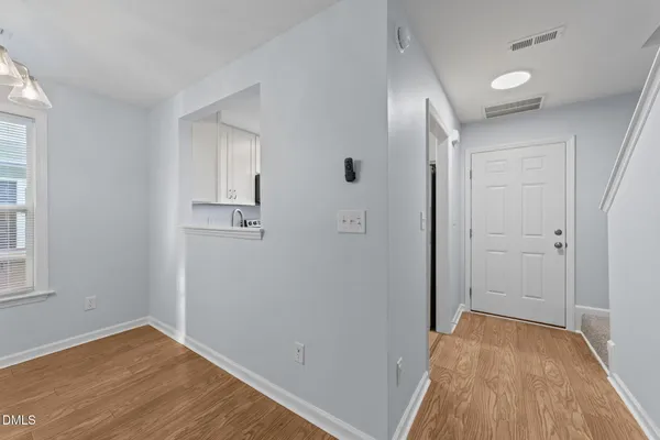 a view of a room with wooden floor and bathroom