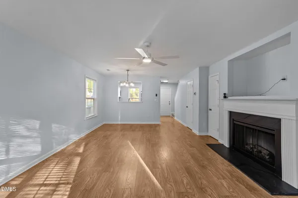 a view of an empty room and window and fire place
