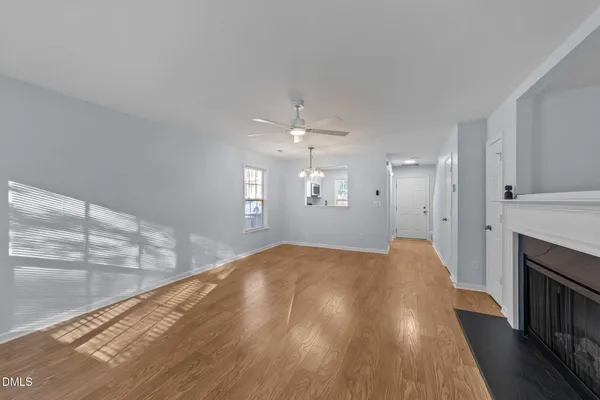 a view of a livingroom with a ceiling fan window and wooden floor