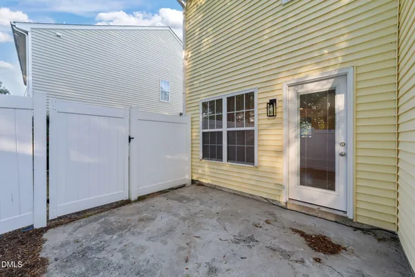a view of a house with a large window and wooden door