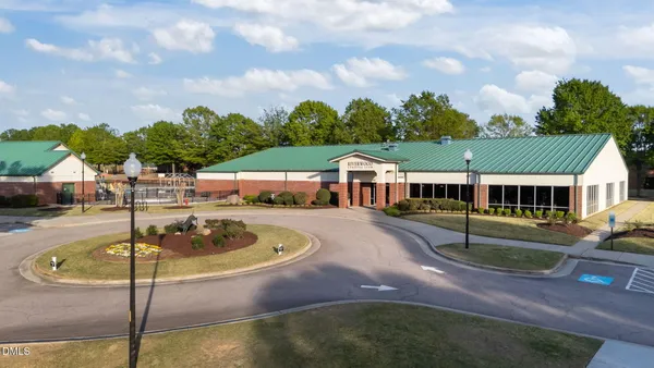 a swimming pool with outdoor seating and yard