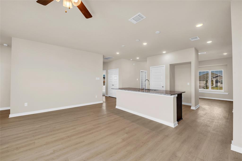 262 Boatright Boulevard Jarrell, TX 76537 - Photo 29 of 30 Kitchen featuring a center island with sink, recessed lighting, ceiling fan, dark stone counters, and open floor plan