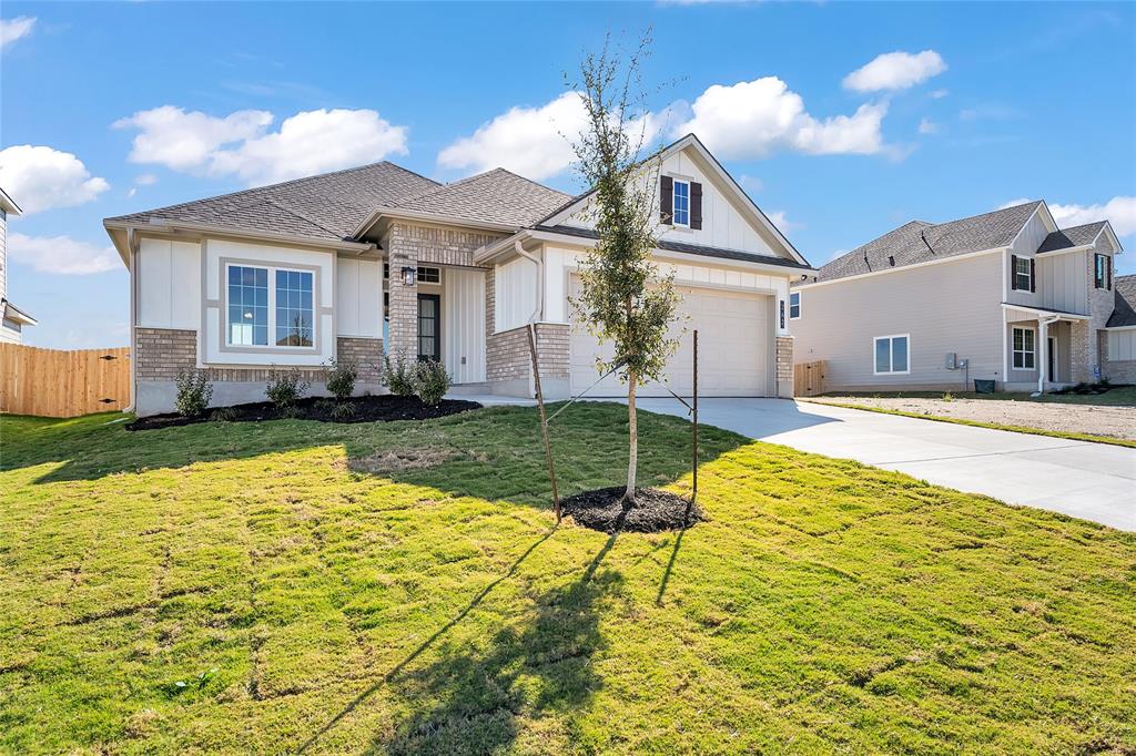 262 Boatright Boulevard Jarrell, TX 76537 - Photo 2 of 30 View of front facade featuring concrete driveway, brick siding, and board and batten siding