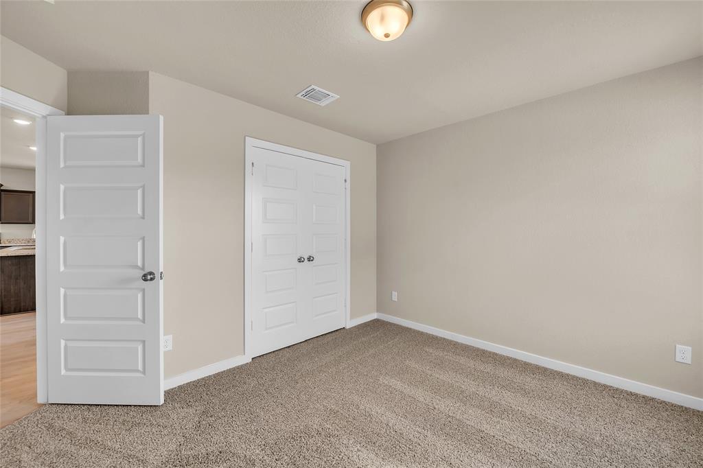 262 Boatright Boulevard Jarrell, TX 76537 - Photo 6 of 30 Unfurnished bedroom featuring light colored carpet and a closet